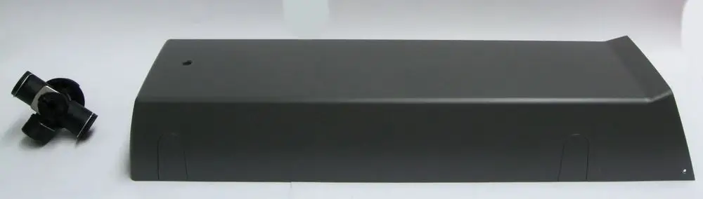 Schwarze Abdeckung und ein Verbindungselement, die möglicherweise Teil eines Umbausets von Daikin sind, auf hellem Hintergrund.